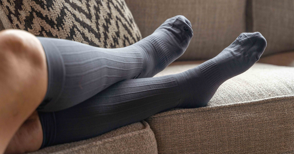 Lady wearing the OrthoSleeve Medical Grade Compression Socks while sitting down