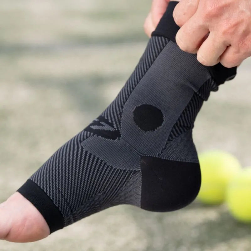 Close-up image of someone putting on the OrthoSleeve Compression Ankle Brace