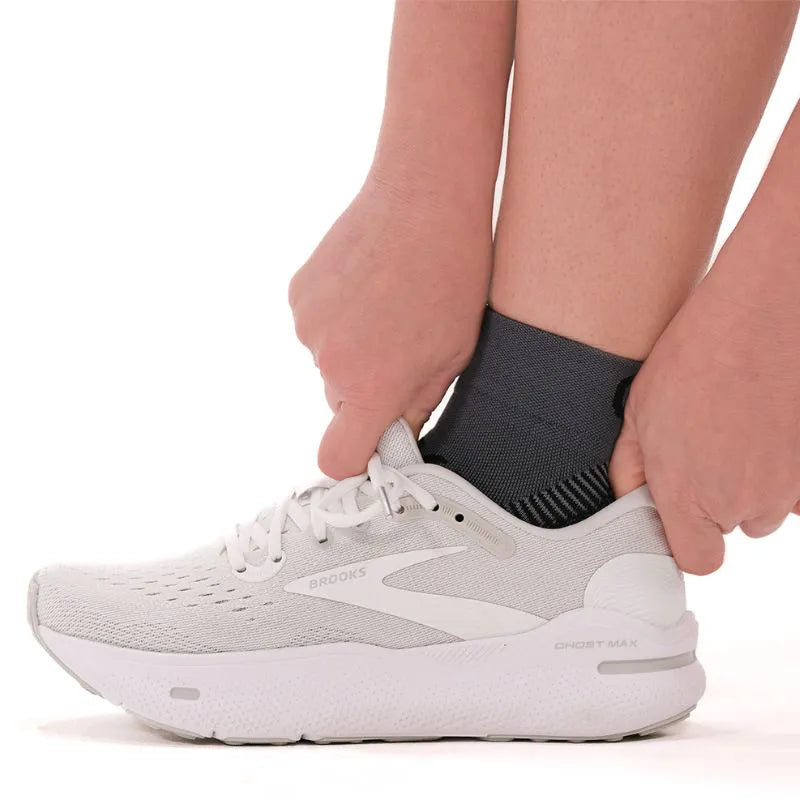 Lifestyle image of the charcoal quarter crew plantar fasciitis socks being worn with shoes