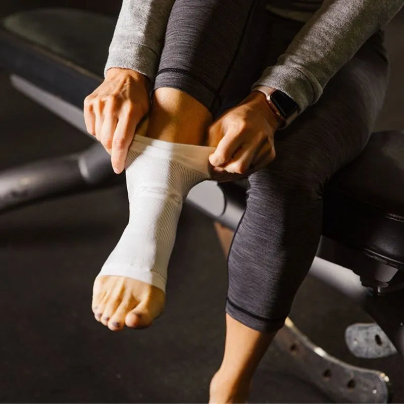 Up-close of a woman putting on the OrthoSleeve DS6 Plantar Fasciitis Night Sleeve