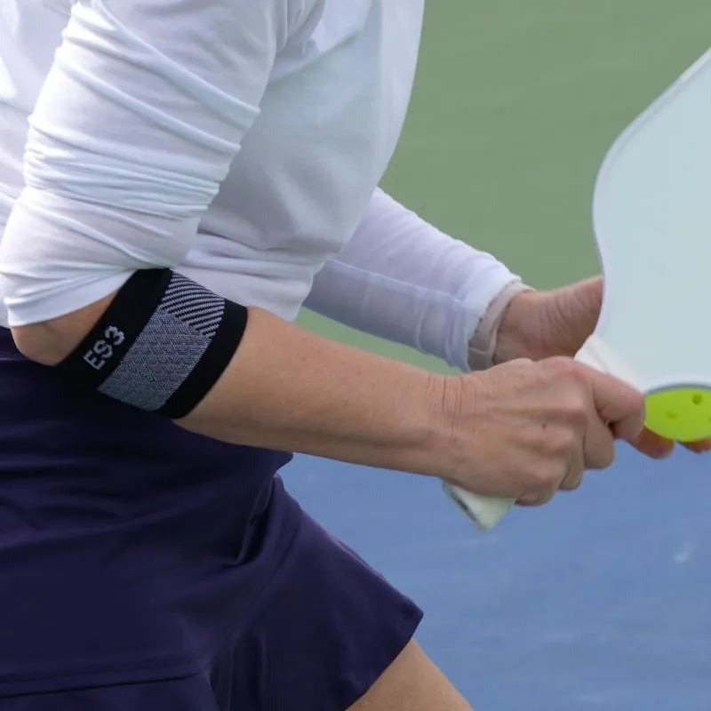 Woman wearing the OrthoSleeve ES3 Compression Elbow Brace while playing pickleball