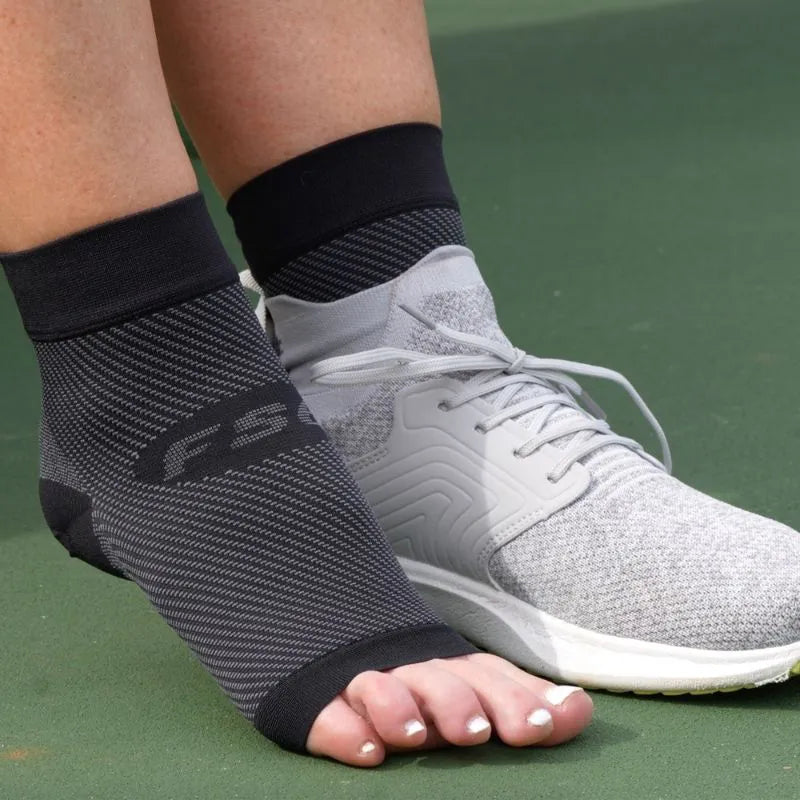 Person wearing the OrthoSleeve Plantar Fasciitis Foot Sleeves before playing pickleball