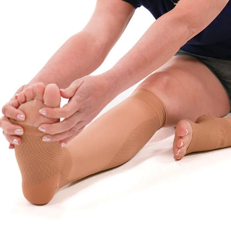 Person shown wearing the tan compression leg sleeves while stretching