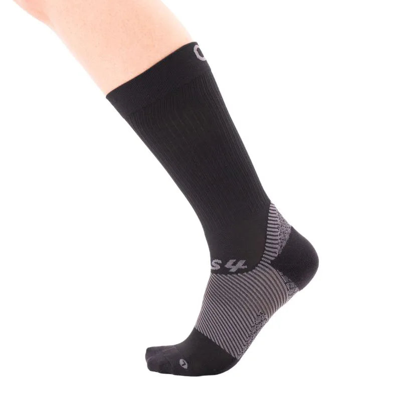 Single foot wearing the crew length black OrthoSleeve plantar fasciitis sock