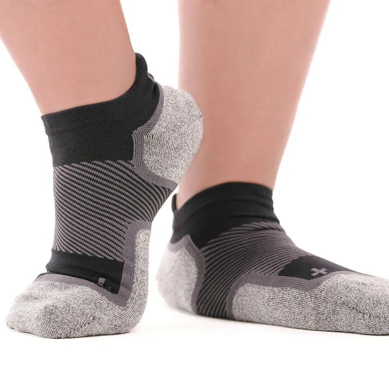 Person wearing the OrthoSleeve Wide Wellness Compression Socks in black no show length