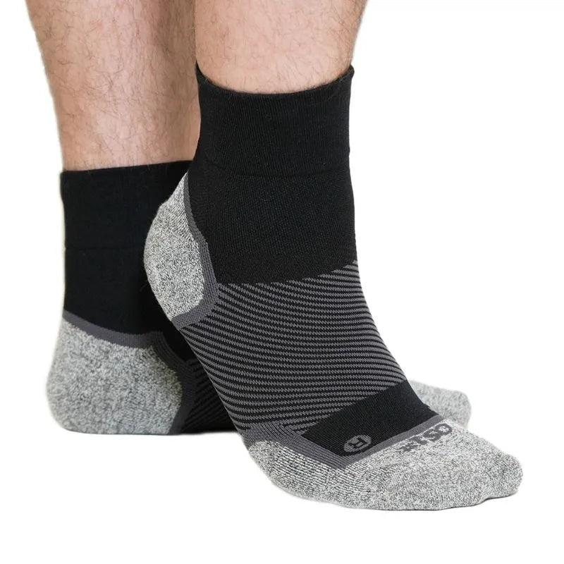 Person wearing the OrthoSleeve Wide Wellness Care socks in black quarter crew length