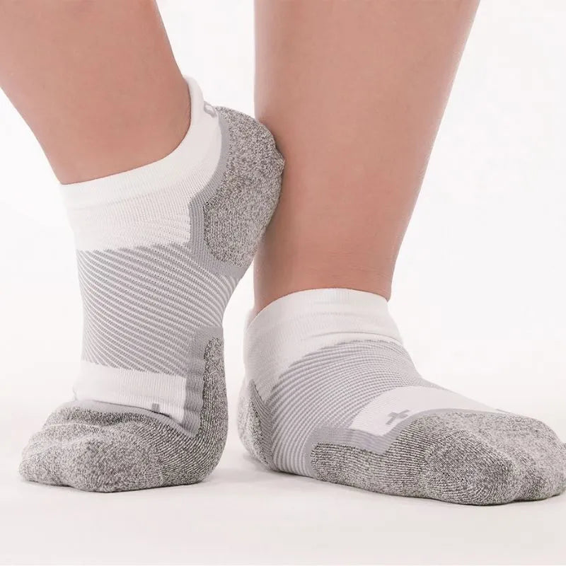 Person wearing the OrthoSleeve Wide Wellness Compression Socks in white no show length