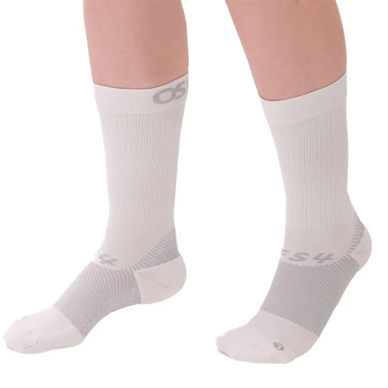 Person wearing a pair of the OrthoSleeve white crew length plantar fasciitis socks